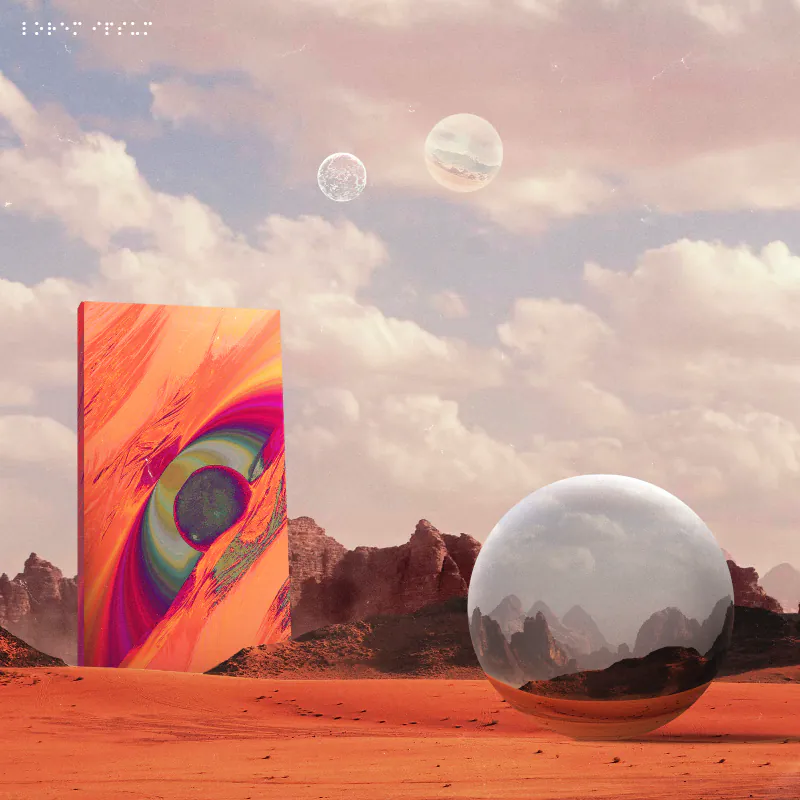 Painted monolith and chrome sphere in a red desert